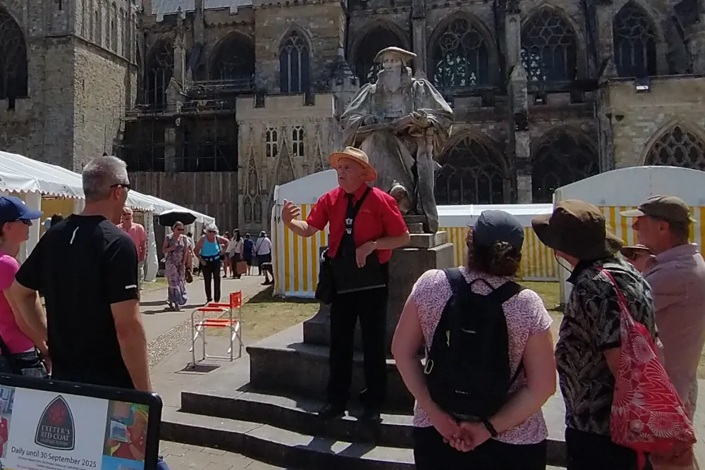 Exeter Red Coat Guide speaking to visitors during a walking tour