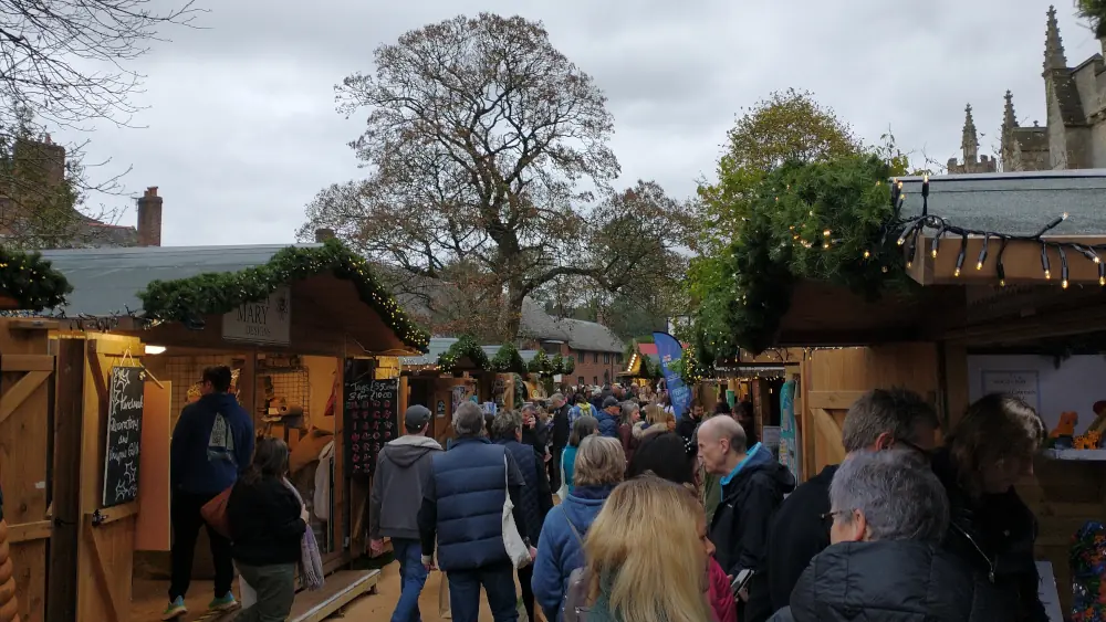 Wooden stalls and festive lights at Exeter Christmas Market on Cathedral Green