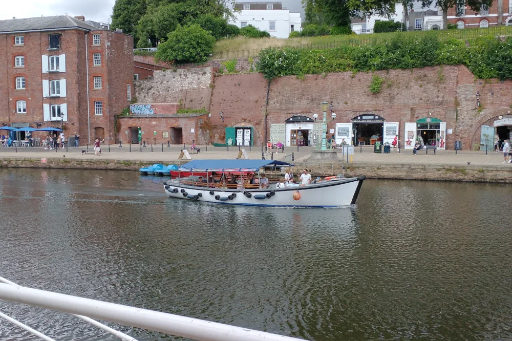Visitors enjoying a boat trip along the Exeter Quay