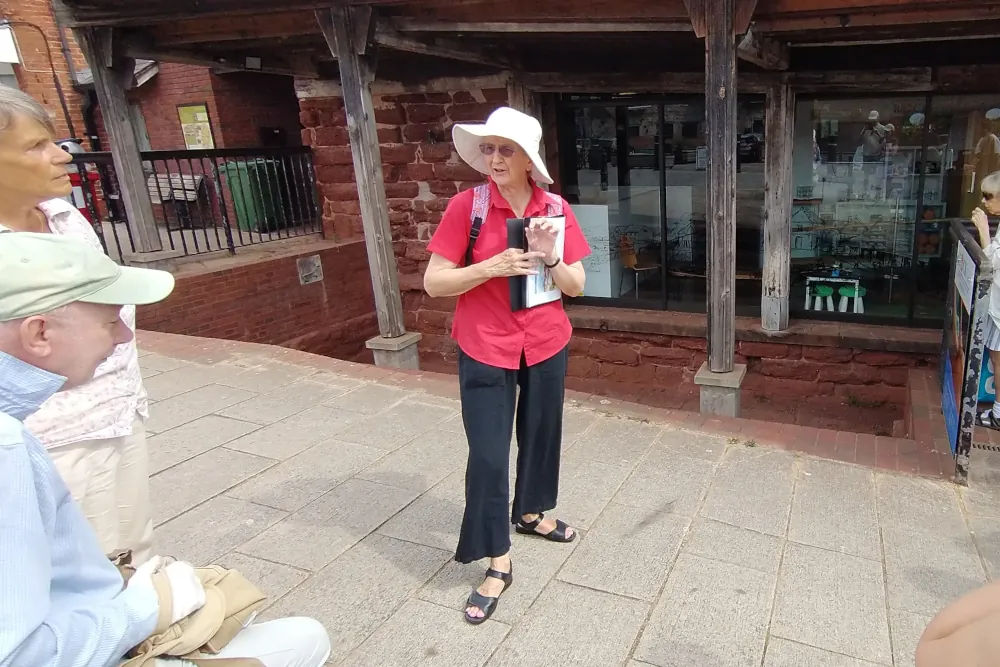Red Coat Guide explaining the history of Exeter Quay close to the Custom House